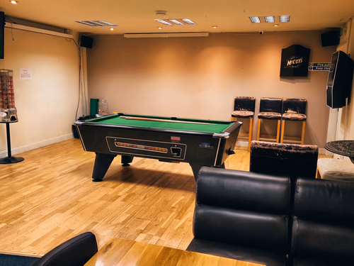 Inside the Tow-Bar, with a pool table, seating and a big screen
