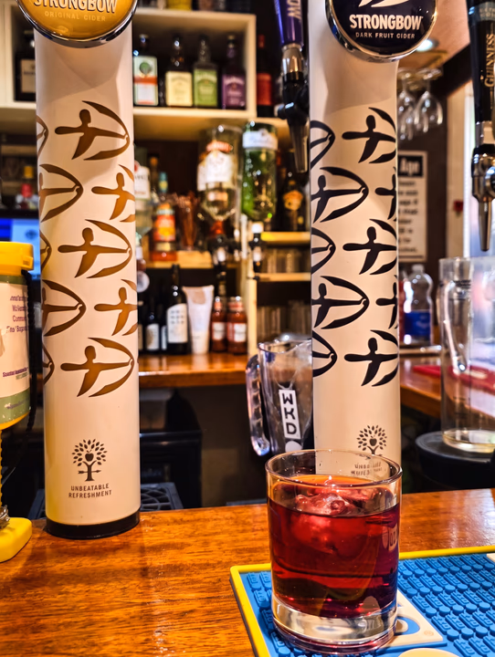 Draught fonts on the bar at the Tow-Bar, with spirits on the shelves behind